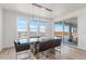 Contemporary dining room featuring a glass table, modern chandelier, and sliding glass doors to the patio at 89 Clara Pl, Castle Pines, CO 80108