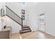 Inviting entryway with hardwood floors, staircase, and white door with glass panels at 89 Clara Pl, Castle Pines, CO 80108