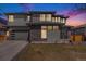Beautiful two-story home with a modern design, featuring a stone facade and a well-manicured lawn at 89 Clara Pl, Castle Pines, CO 80108