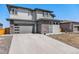 Contemporary two-story home with a clean design, featuring a stone facade, and modern garage door at 89 Clara Pl, Castle Pines, CO 80108