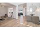 Welcoming foyer leading to the kitchen and living spaces, featuring modern decor and light hardwood floors at 89 Clara Pl, Castle Pines, CO 80108