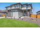 Modern two-story home featuring manicured lawn, stone accents, and large windows at 89 Clara Pl, Castle Pines, CO 80108