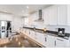 Well-appointed kitchen with black granite countertops, stainless appliances, and bright white cabinets at 89 Clara Pl, Castle Pines, CO 80108
