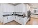 Elegant kitchen with white cabinetry, black countertops, and stainless steel appliances at 89 Clara Pl, Castle Pines, CO 80108