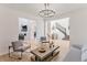 Open-concept living area with modern furnishings, leading to other rooms and a staircase at 89 Clara Pl, Castle Pines, CO 80108