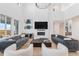 Bright living room with soaring ceilings, a modern fireplace, and comfortable seating at 89 Clara Pl, Castle Pines, CO 80108