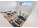 Open-concept living room with a large kitchen and dining area, flooded with natural light at 89 Clara Pl, Castle Pines, CO 80108