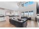 Open-concept living space with tall ceilings, modern light fixture, and ample natural light at 89 Clara Pl, Castle Pines, CO 80108