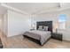Bright and airy bedroom features an oversized bed with hardwood floors and side tables at 89 Clara Pl, Castle Pines, CO 80108