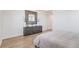 This stylish bedroom features a hardwood floor, modern dresser, and decorative mirror at 89 Clara Pl, Castle Pines, CO 80108