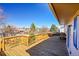 Wide angle shot of wood deck with a grass yard and mature trees, perfect for outdoor entertaining at 1244 S Argonne Cir, Aurora, CO 80017