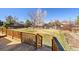 Large backyard featuring a wood deck, mature trees and grass yard at 1244 S Argonne Cir, Aurora, CO 80017