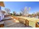 Large wood deck, perfect for outdoor entertaining, overlooking a spacious yard with mature trees at 1244 S Argonne Cir, Aurora, CO 80017