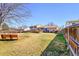 Large backyard featuring a grass yard, mature trees, deck and fencing at 1244 S Argonne Cir, Aurora, CO 80017
