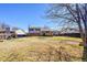 Expansive backyard with lush lawn and mature trees, offering privacy and space for outdoor activities at 1244 S Argonne Cir, Aurora, CO 80017