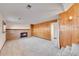 Spacious basement with brick fireplace, shelving, and wood paneling at 1244 S Argonne Cir, Aurora, CO 80017