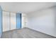 Bedroom with sliding closet doors and neutral-toned carpet flooring at 1244 S Argonne Cir, Aurora, CO 80017
