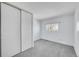Bedroom with a sliding closet door and a large window at 1244 S Argonne Cir, Aurora, CO 80017