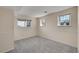 Neutral finished basement bedroom featuring three windows and neutral carpet at 1244 S Argonne Cir, Aurora, CO 80017