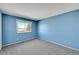 Bedroom featuring a large window, neutral carpet and ample square footage at 1244 S Argonne Cir, Aurora, CO 80017