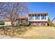 Charming two-story home with blue shutters and a spacious front yard at 1244 S Argonne Cir, Aurora, CO 80017
