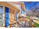 Inviting front porch with wooden bench and blue shutters, offering a warm welcome at 1244 S Argonne Cir, Aurora, CO 80017