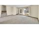 Spacious living room featuring new carpet and a view of the front yard at 1244 S Argonne Cir, Aurora, CO 80017