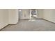 Light-filled living room with a large window and neutral carpet at 1244 S Argonne Cir, Aurora, CO 80017