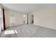 Spacious main bedroom featuring neutral tones, plush carpeting, and ensuite bathroom access at 1244 S Argonne Cir, Aurora, CO 80017