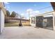 Concrete patio with fire pit and view of the backyard at 7481 Bronco Rd, Denver, CO 80221