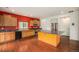 Well-lit kitchen with a large island, wood cabinets, stainless steel appliances, and hardwood floors at 12921 E 108Th Way, Commerce City, CO 80022