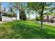 Lush green backyard featuring a lawn and mature trees offering privacy at 150 Blue Spruce Ct, Highlands Ranch, CO 80126