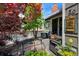 Private backyard with mature tree, wood deck, and lush landscaping at 150 Blue Spruce Ct, Highlands Ranch, CO 80126