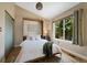 Relaxing bedroom has a large window with views of the outdoors and plush rug at 150 Blue Spruce Ct, Highlands Ranch, CO 80126