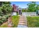 Charming home with well-maintained lawn, lush trees, and inviting walkway to front door at 150 Blue Spruce Ct, Highlands Ranch, CO 80126