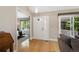 Bright foyer with wood floors, white door and trim with open view of bedroom and outside patio at 150 Blue Spruce Ct, Highlands Ranch, CO 80126