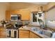 Bright kitchen features stainless appliances, granite counters, and undermount sink at 150 Blue Spruce Ct, Highlands Ranch, CO 80126