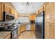 Updated kitchen with stainless steel appliances, granite counters, and tile flooring at 150 Blue Spruce Ct, Highlands Ranch, CO 80126