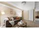 Cozy living room featuring a brown sofa, two round wood tables and neutral decor at 150 Blue Spruce Ct, Highlands Ranch, CO 80126