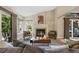 Inviting living room with fireplace, vaulted ceiling, and large windows at 150 Blue Spruce Ct, Highlands Ranch, CO 80126