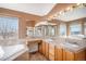 Bathroom featuring dual sinks, a soaking tub, and a separate shower for convenience at 10765 Willow Reed Ct, Parker, CO 80134