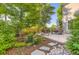 Back patio features outdoor seating and mature landscaping with tall trees for plenty of shade at 10472 Longleaf Dr, Parker, CO 80134