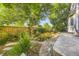 Landscaped backyard featuring a stone patio, rock garden, flowering plants, and a wooden fence for privacy at 10472 Longleaf Dr, Parker, CO 80134