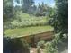 View from an upper story window of the backyard featuring mature greenery and a privacy fence at 10472 Longleaf Dr, Parker, CO 80134