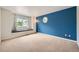 Bedroom features a blue accent wall and window seat with large, bright windows at 10472 Longleaf Dr, Parker, CO 80134