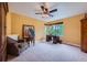 Bright bedroom features a ceiling fan, large window, and sitting area with chair and side table at 10472 Longleaf Dr, Parker, CO 80134