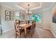 The dining room is bright with crown molding and a view into the kitchen, perfect for entertaining at 10472 Longleaf Dr, Parker, CO 80134