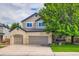 Charming two-story home with a three-car garage, landscaped yard, and welcoming front porch at 10472 Longleaf Dr, Parker, CO 80134