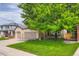 Charming two-story home with manicured front lawn, mature tree, and a two car garage at 10472 Longleaf Dr, Parker, CO 80134