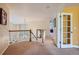 Hallway with oak railing that leads to a yellow walled room with french doors at 10472 Longleaf Dr, Parker, CO 80134